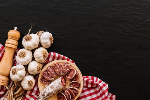 Garlic sausages near spices napkin