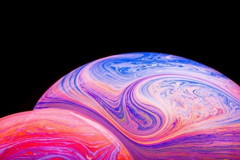 Gradient multicolored soap bubbles black background