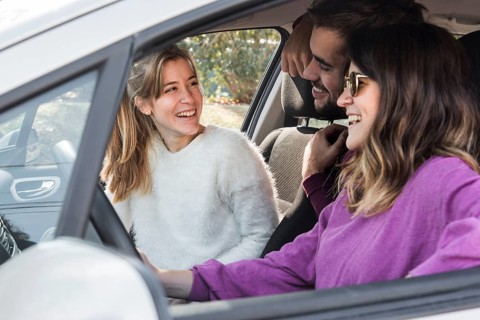 Happy people riding car