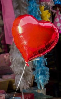 Little red color heart shape balloon in a bazaar