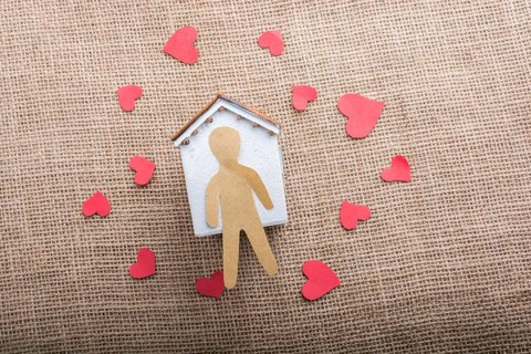 Heart shaped icons and paper house on canvas
