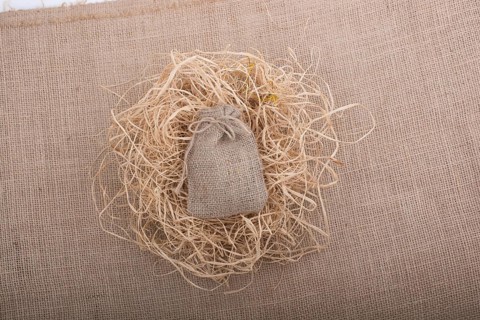 Sack placed on straw on canvas background