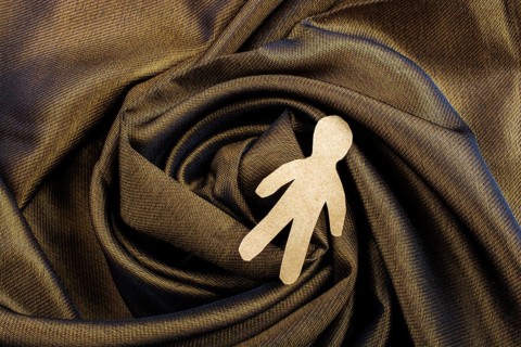 Man shape cut out of paper in hand in the view