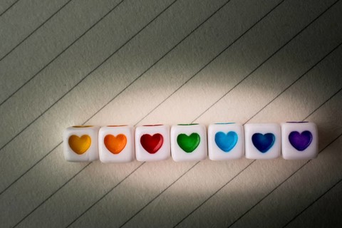 Colorful cubes with a heart placed on paper