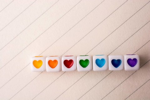 Colorful cubes with a heart placed on paper