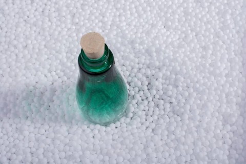 Empty bottle on little white polystyrene foam balls