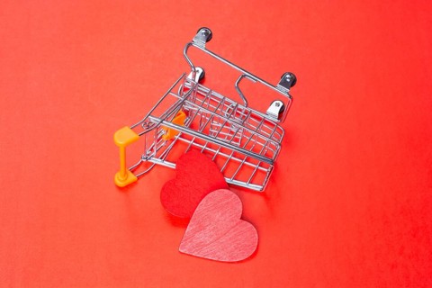 Red hearts and shopping cart. Valentines Day background. Greeting card for holiday