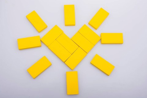 Colorful domino pices are forming a Sun shape