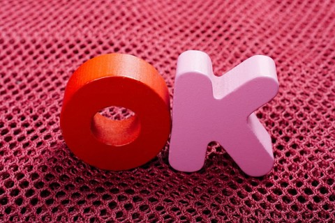 The word OK written with colorful letter blocks
