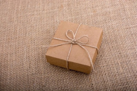 Gift box of brown color on linen canvas