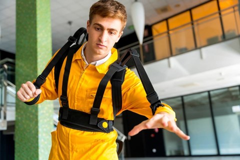 Employee with an exoskeleton from a futuristic high-tech warehouse