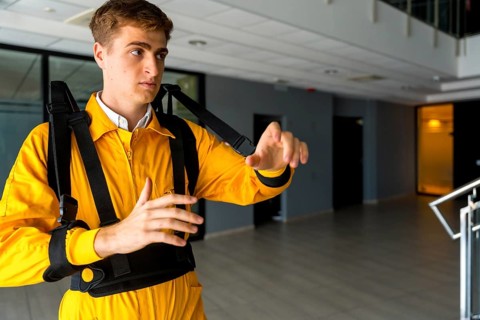 Employee with an exoskeleton from a futuristic high-tech warehouse
