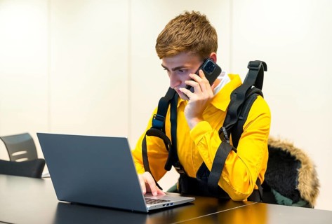 Employee with an exoskeleton from a futuristic high-tech warehouse