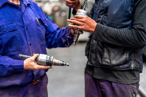 Unrecognizable operators with numerical control metal industrial factory machine tools