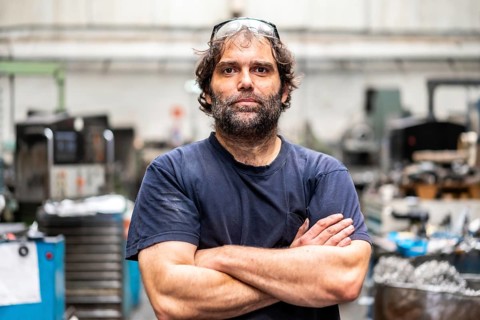 Portrait of a metal industrial factory worker in the numerical control sector with his arms crossed
