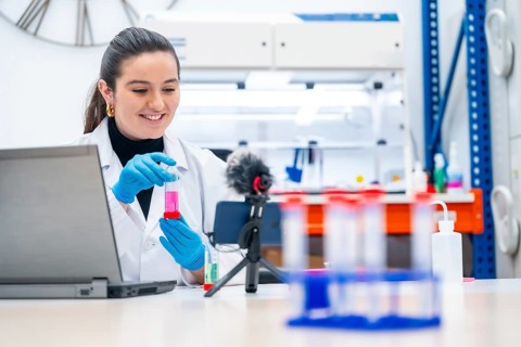 Young female biologist recording a video showing samples in a research laboratory
