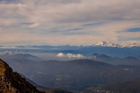 Aerial View over a Beautiful Mountainscape and And Snow Capped Monte Rosa and Mountain Peak Matterhorn and with Floating Clouds in a Sunny Day in Ticino