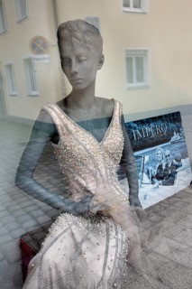 Shop window with fashion mannequin in evening dress
