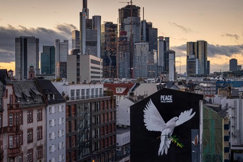 PEACE FOR ALL MANKIND is written above the image of a giant dove of peace on the wall of a house in Frankfurt am Main: a message of peace in the contemporary historical context of the escalated Middle...