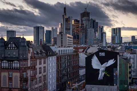 PEACE FOR ALL MANKIND is written above the image of a giant dove of peace on the wall of a house in Frankfurt am Main: a message of peace in the contemporary historical context of the escalated Middle...