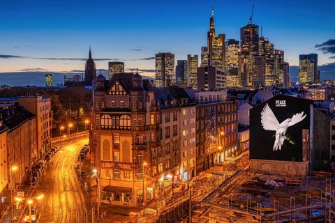PEACE FOR ALL MANKIND is written above the image of a giant dove of peace on the wall of a house in Frankfurt am Main: a message of peace in the contemporary historical context of the escalated Middle...