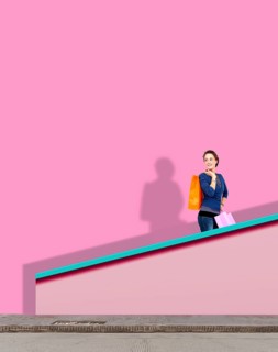 Woman goes up a flight of stairs with her shopping