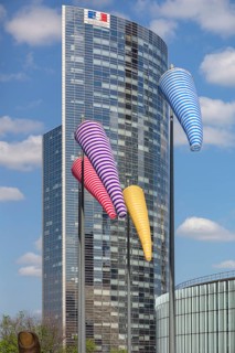 Office tower with colourful windsocks in front of it