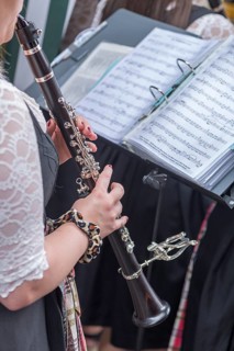 Musician with clarinet and sheet music plays for dancing at the traditional Tanzlindenfest in Limmersdorf