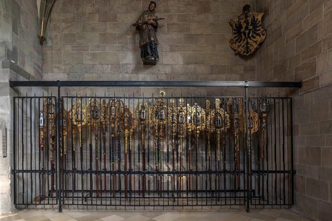 Richly decorated processional poles secured by a grille