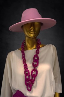 Mannequin with a hat and a fashionable necklace in a fashion shop