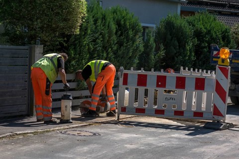Construction workers flexing a road