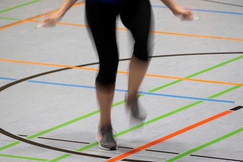 Woman rope skipping in a gymnasium