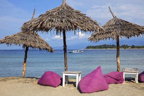 Parasols of beach restaurant on the island Gili Trawangan