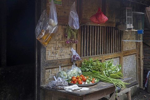 Food for sale in front of traditional bamboo house in the village Sade
