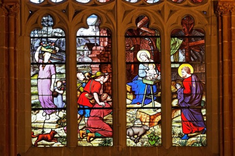 Colourful stained glass window depicting the birth of Jesus