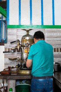 Preparing coffee on a historic espresso machine