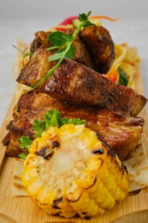 Grilled beef ribs served with garnish