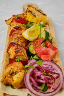 Chicken skewer served with pickled vegetables