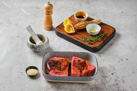 Marinated with spice and lemon juice ahi tuna steak in a bowl