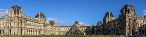 Panoramic photo of the Louvre Museum building and the glass pyramid