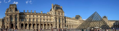 Panoramic photo of the Louvre Museum building and the glass pyramid