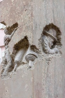 Detail with a carved stone figure on a stone column from the monument Jewish Life in Rottenburg by the artist Ralf Ehmann Eskefen