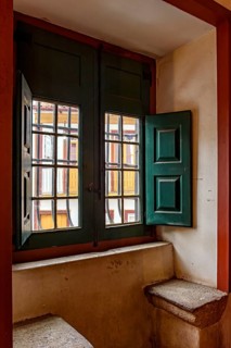 Old window inside a historic baroque church with a view of the colonial houses in the city of Ouro Pretro