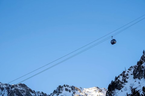 Winter journey unfolds cable car amid Andorra's snowy peaks alpine wonder