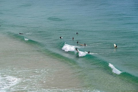 Surfers in the surf at Sagres beach