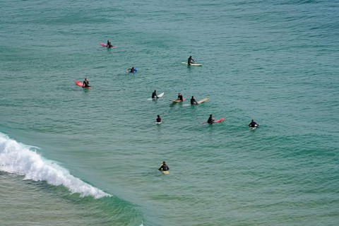 Surfers in the surf at Sagres beach