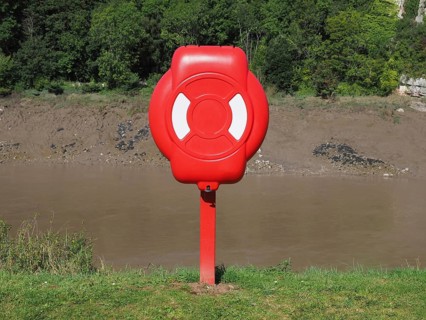 Life buoy on river bank