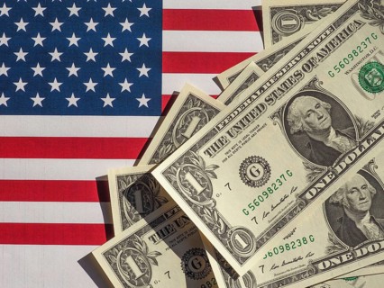 Dollar notes and flag of the United States