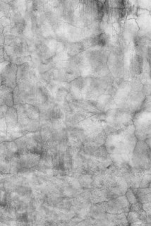Texture of a clay plaster wall in grey tones