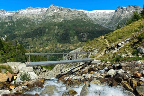 Bridge over the mountain stream Naestbach on the way to the Bietschhornhuette of the Akademischer Alpenclub Bern AACB